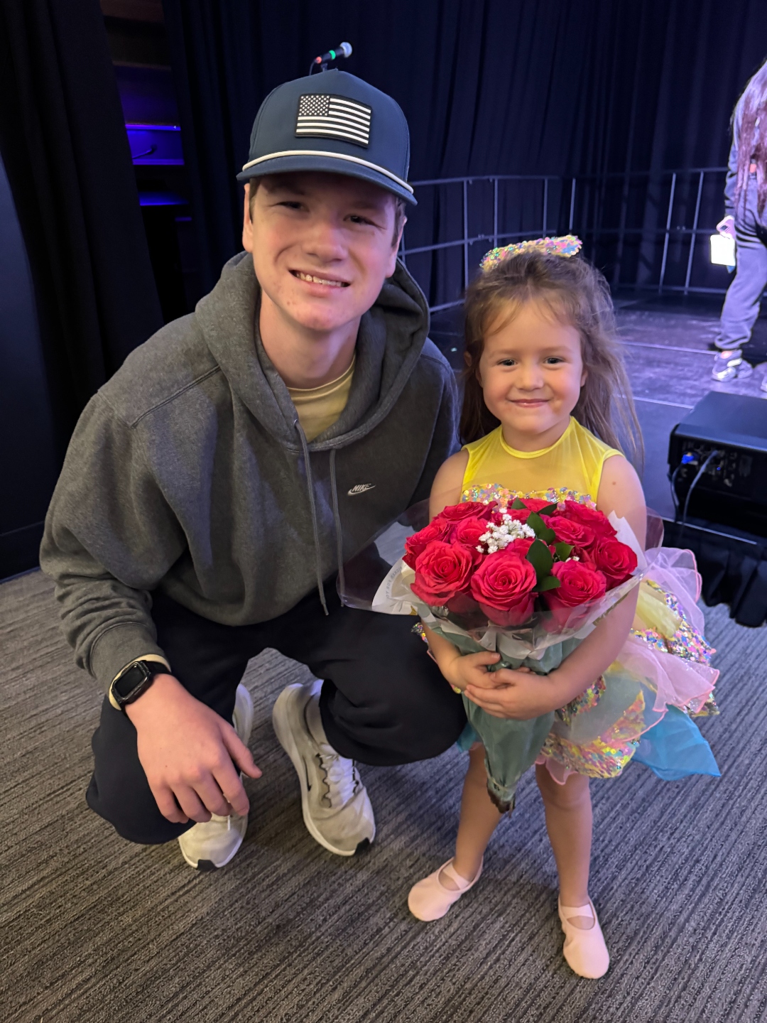 Jackson and Abby, Abby holding a bouquet of roses
